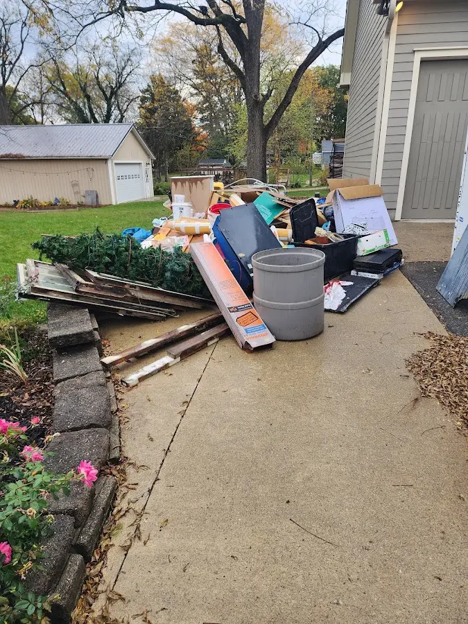 Dumpster being loaded with debris for Roofing Dumpster Rental in Baker City